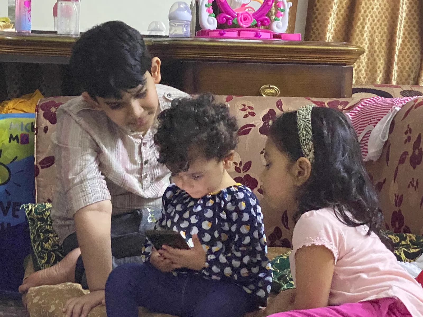 Children using a smartphone.