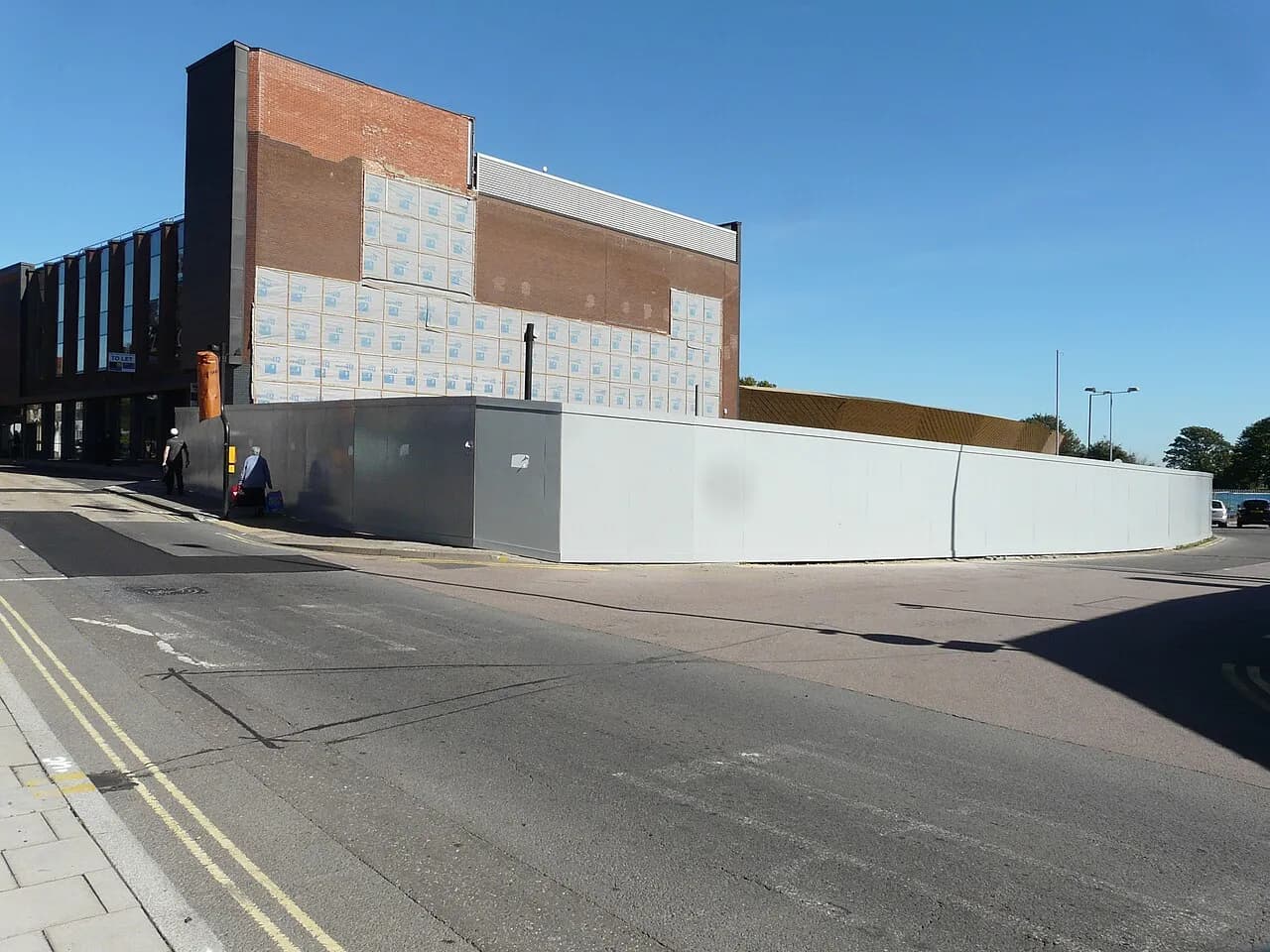 Hoardings around a development site on Queen Street in Colchester, photographed in 2018
