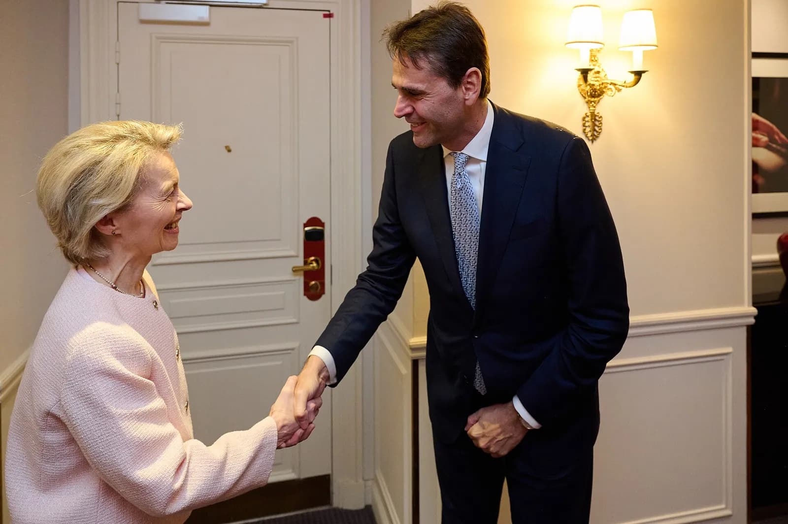 European Commission President Ursula von der Leyen shakes hands with ASML CEO Christophe Fouquet.