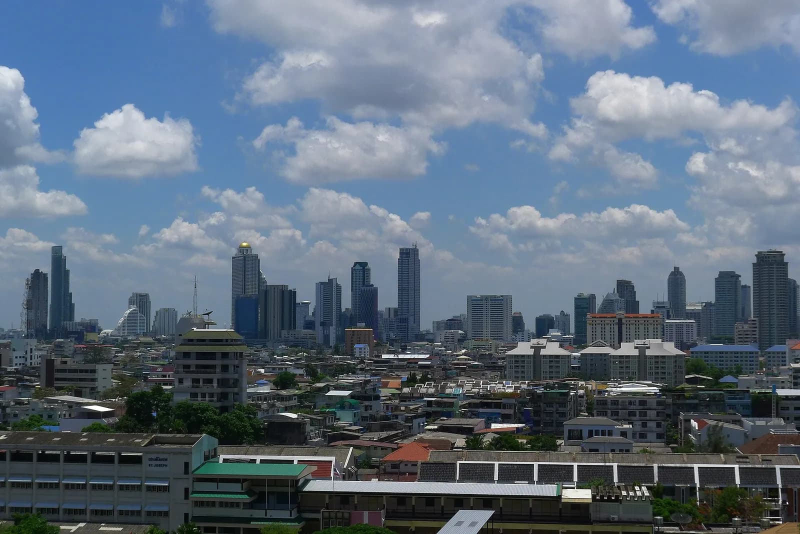 Panoramic view of downtown Bangkok, with high-rise buildings across the skyline.