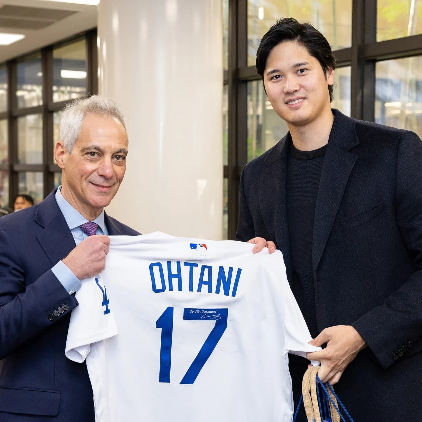 Shohei Ohtani and U.S. Ambassador to Japan Rahm Emanuel hold a Los Angeles Dodgers jersey.