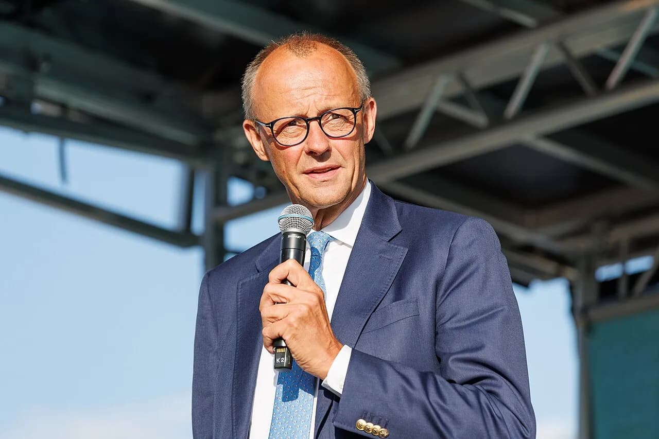 Friedrich Merz speaking into a microphone at a CDU campaign event in Erfurt