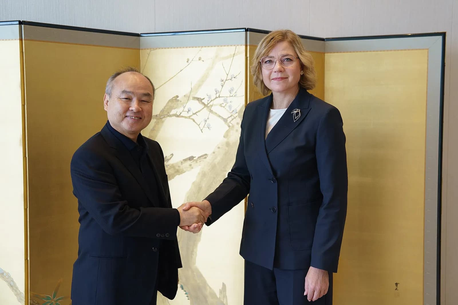 Masayoshi Son and Henna Virkkunen shake hands at SoftBank Group’s headquarters in Tokyo.