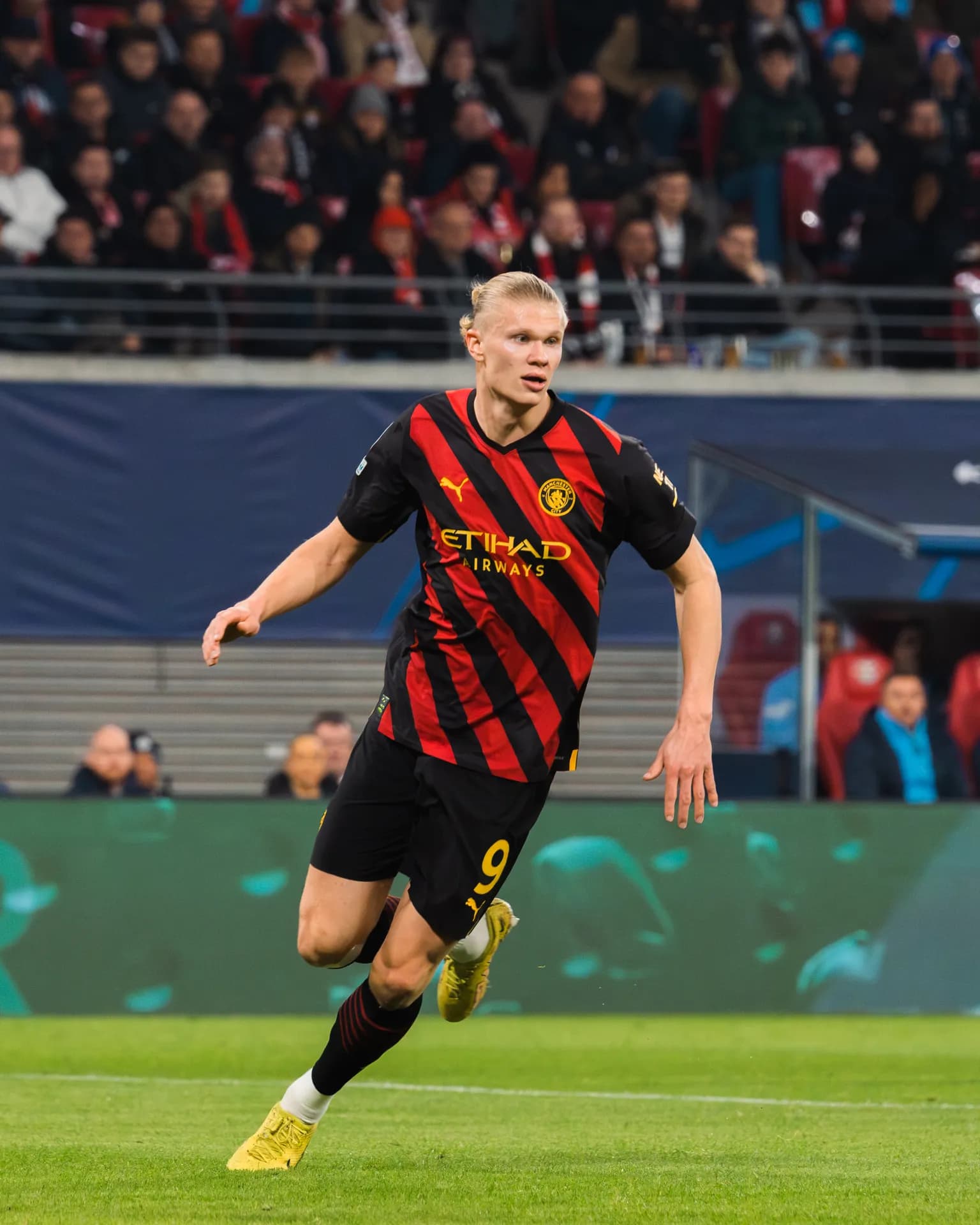 Erling Haaland playing football in a Manchester City kit