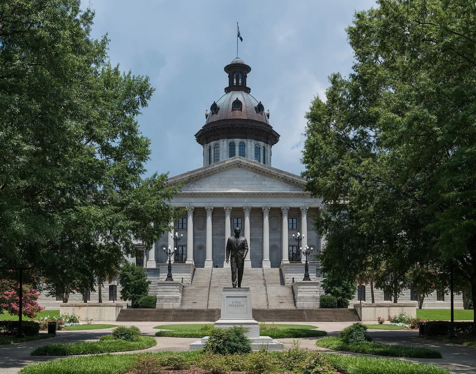 Southeast view of the South Carolina State House and Strom Thurmond statue in Columbia.