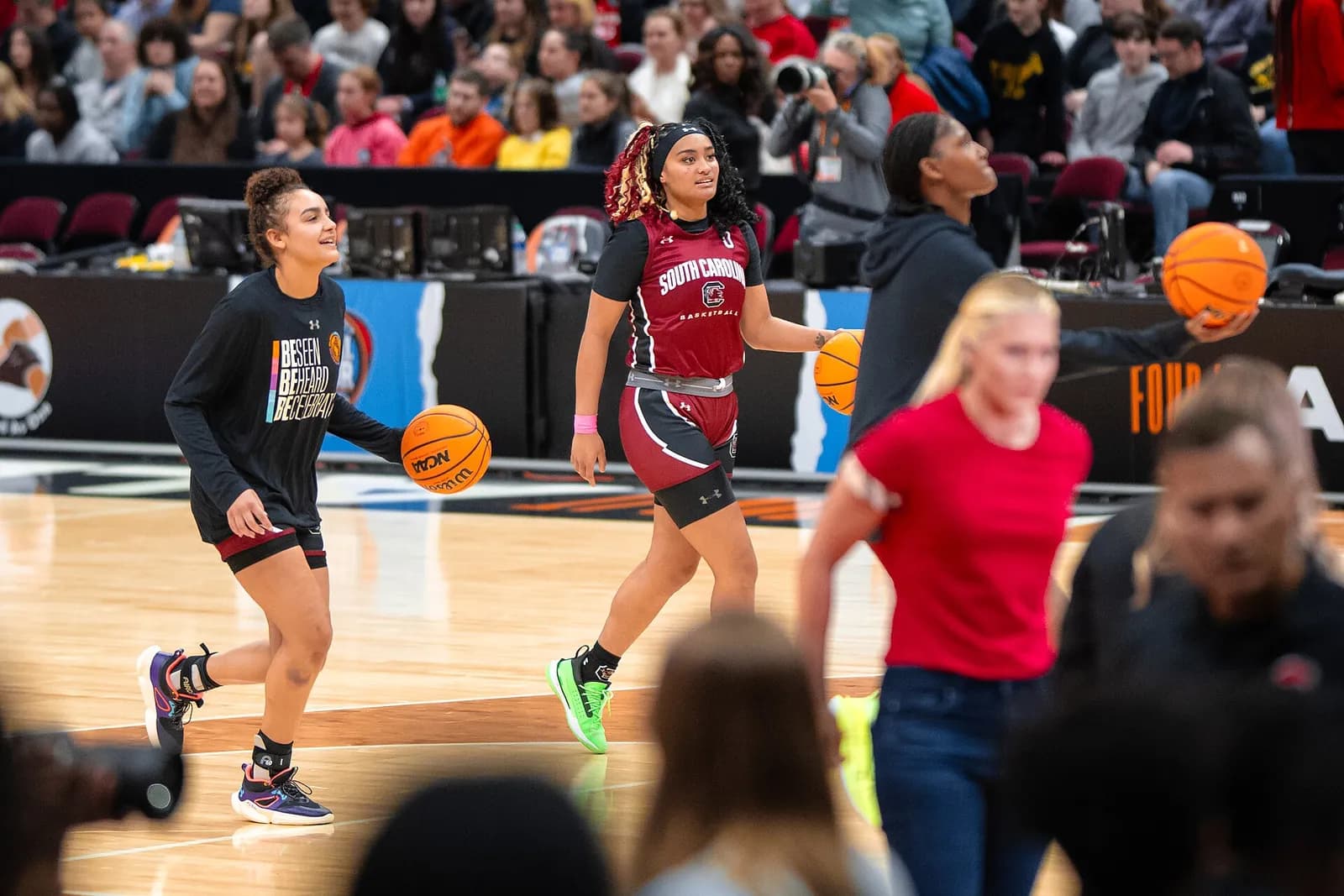 South Carolina women's basketball players warm up on the court.