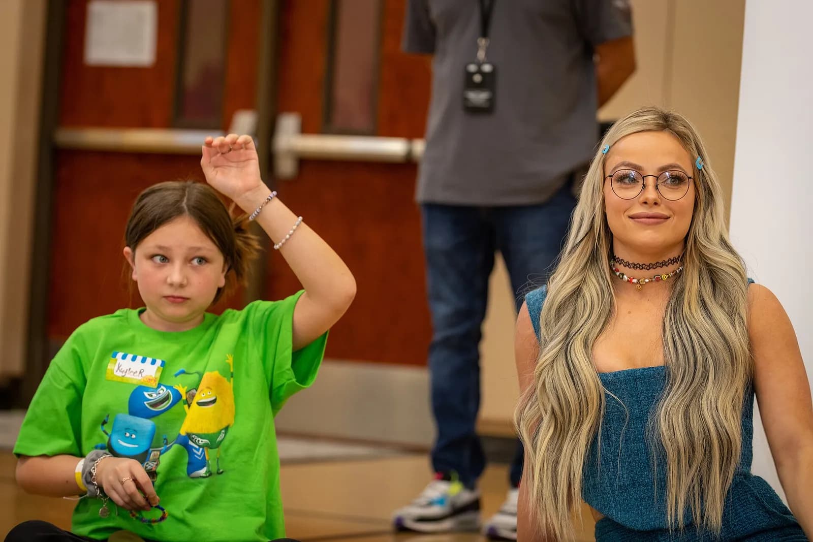 Liv Morgan leads a group activity at a community rally.