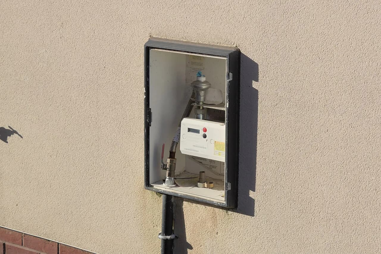 A gas meter visible behind a missing cabinet door