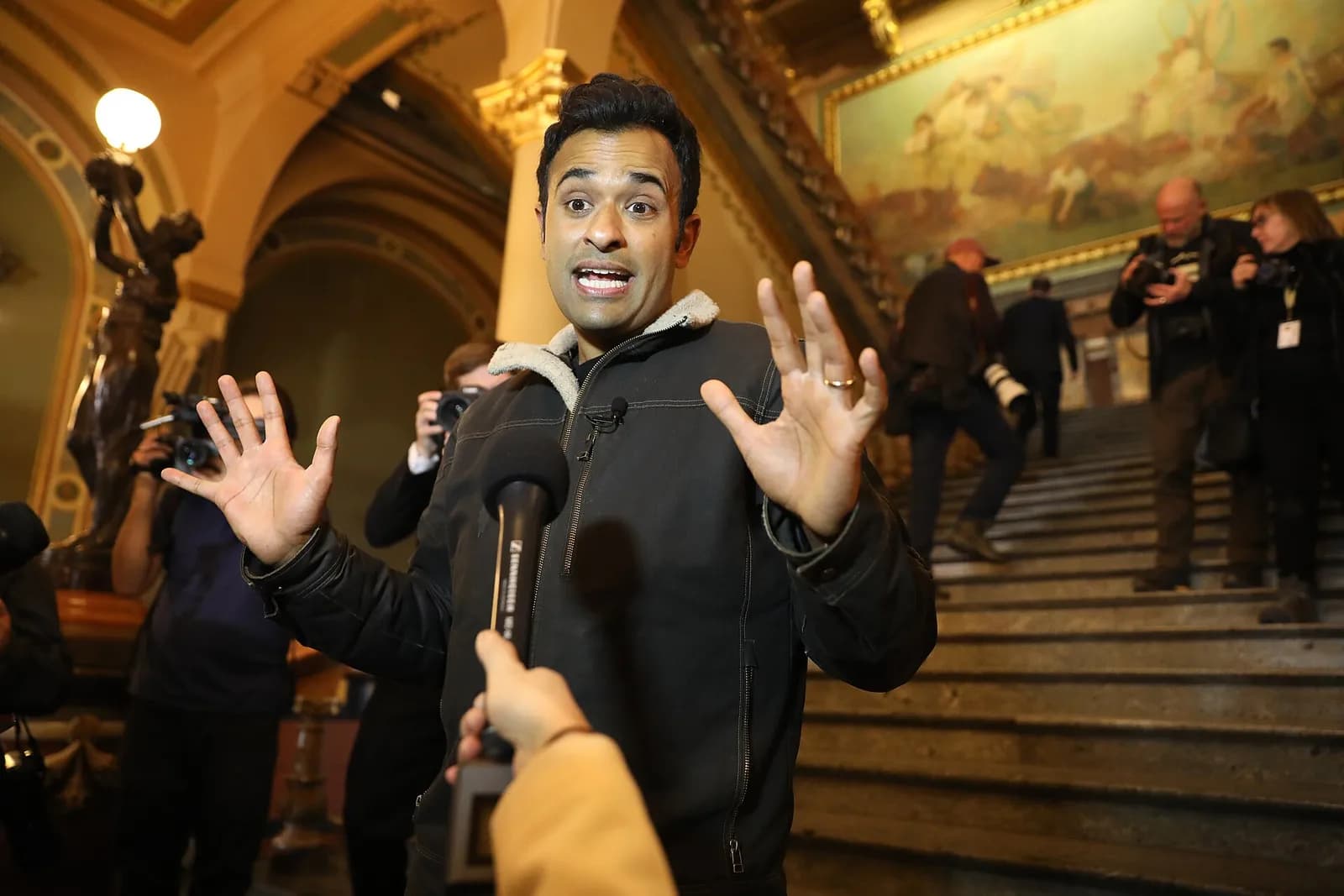 Vivek Ramaswamy speaks with media after a rally at the Iowa State Capitol.