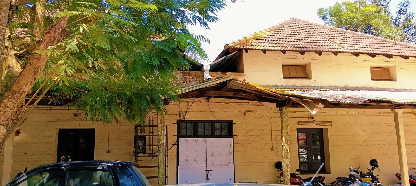 Exterior of the Kerala High Court building, with other buildings nearby.