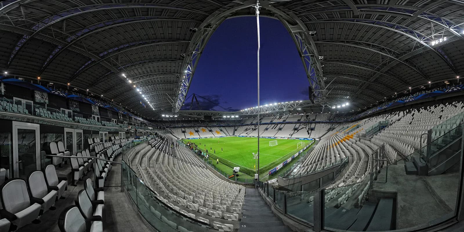 Interior view of Juventus Stadium in Turin, with the pitch and stands visible.