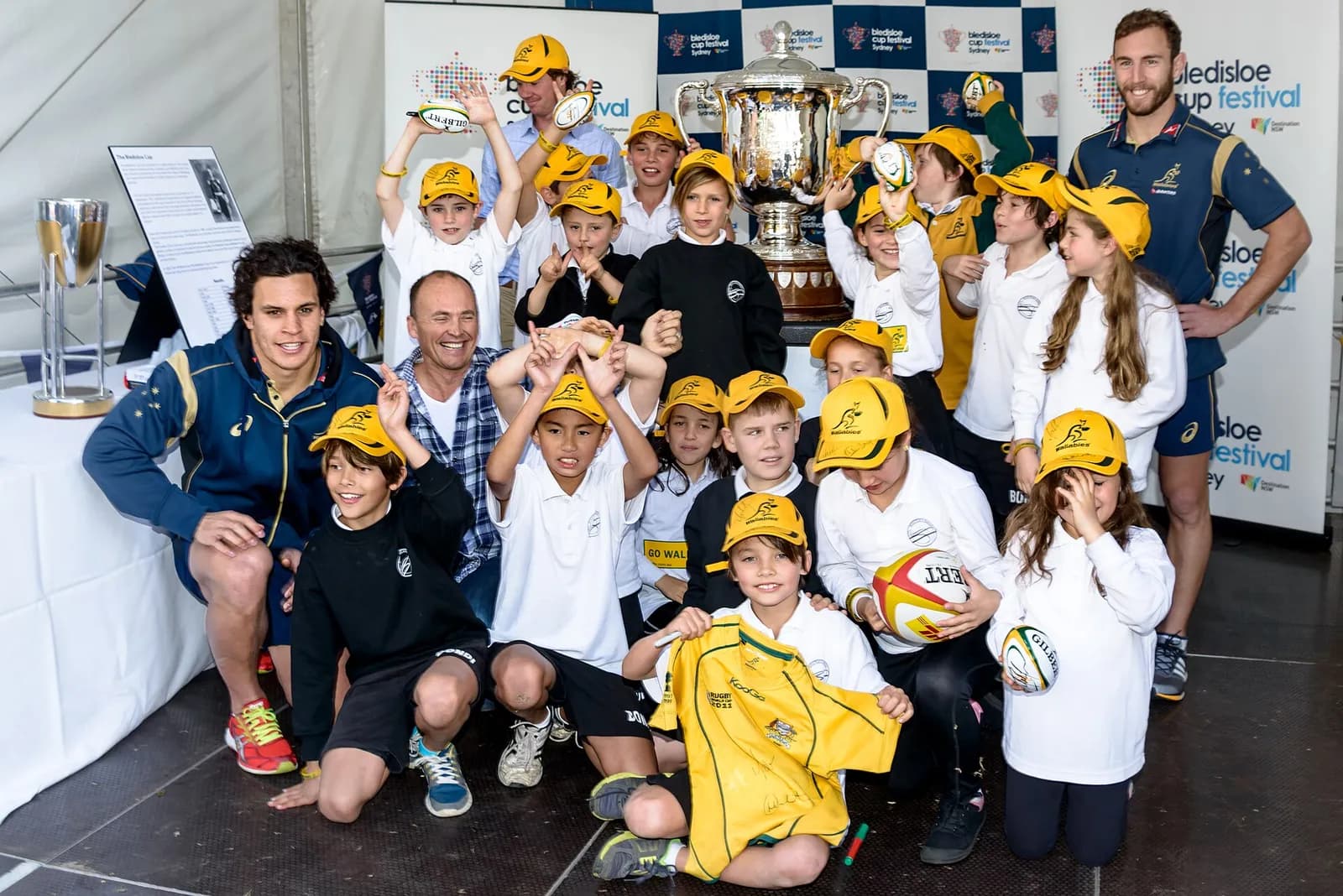 Fans gather around the Bledisloe Cup on display in Sydney.