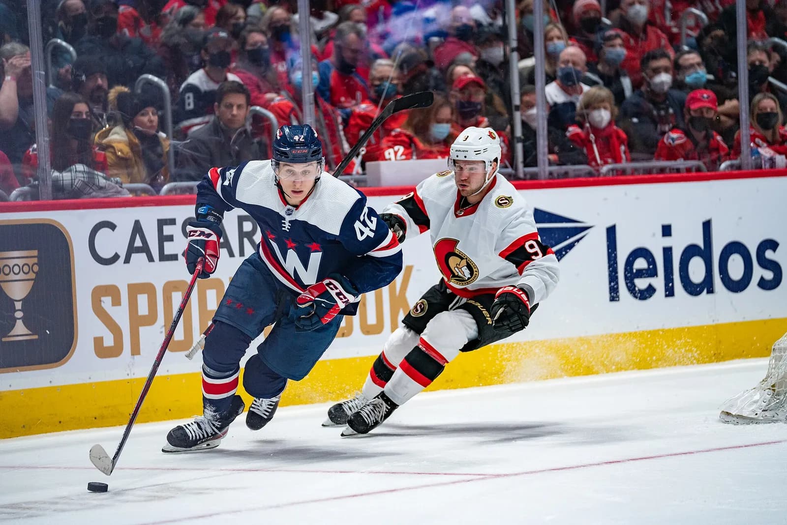 Washington Capitals defenseman Martin Fehérváry skates with Ottawa Senators player Josh Norris nearby during a game at Capital One Arena.