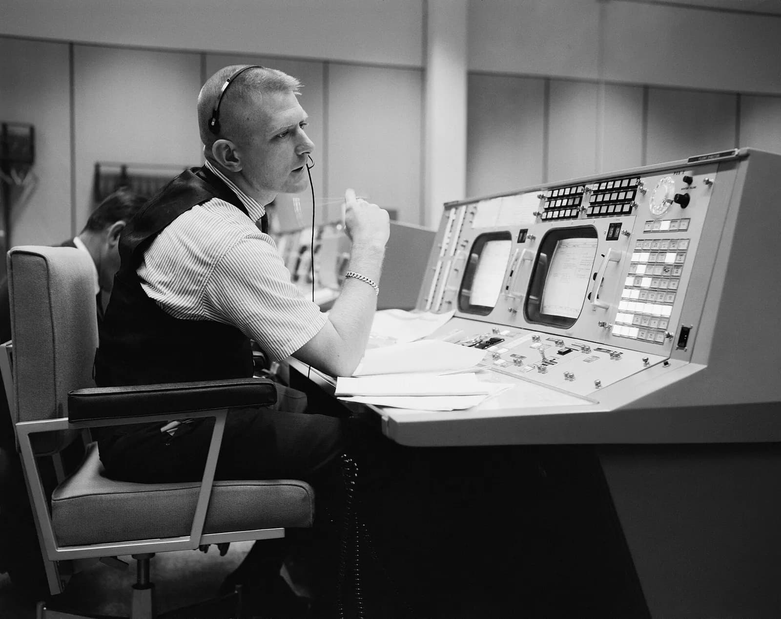 Eugene F. Kranz sits at a console in NASA’s Mission Operations Control Room.