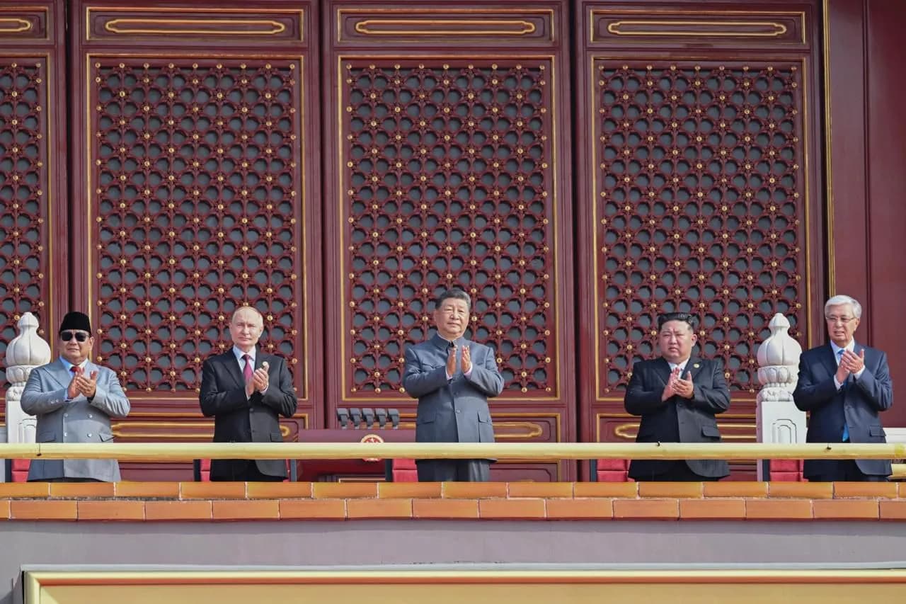 Xi Jinping and Kim Jong-un stand with other national leaders at a military parade in Beijing.