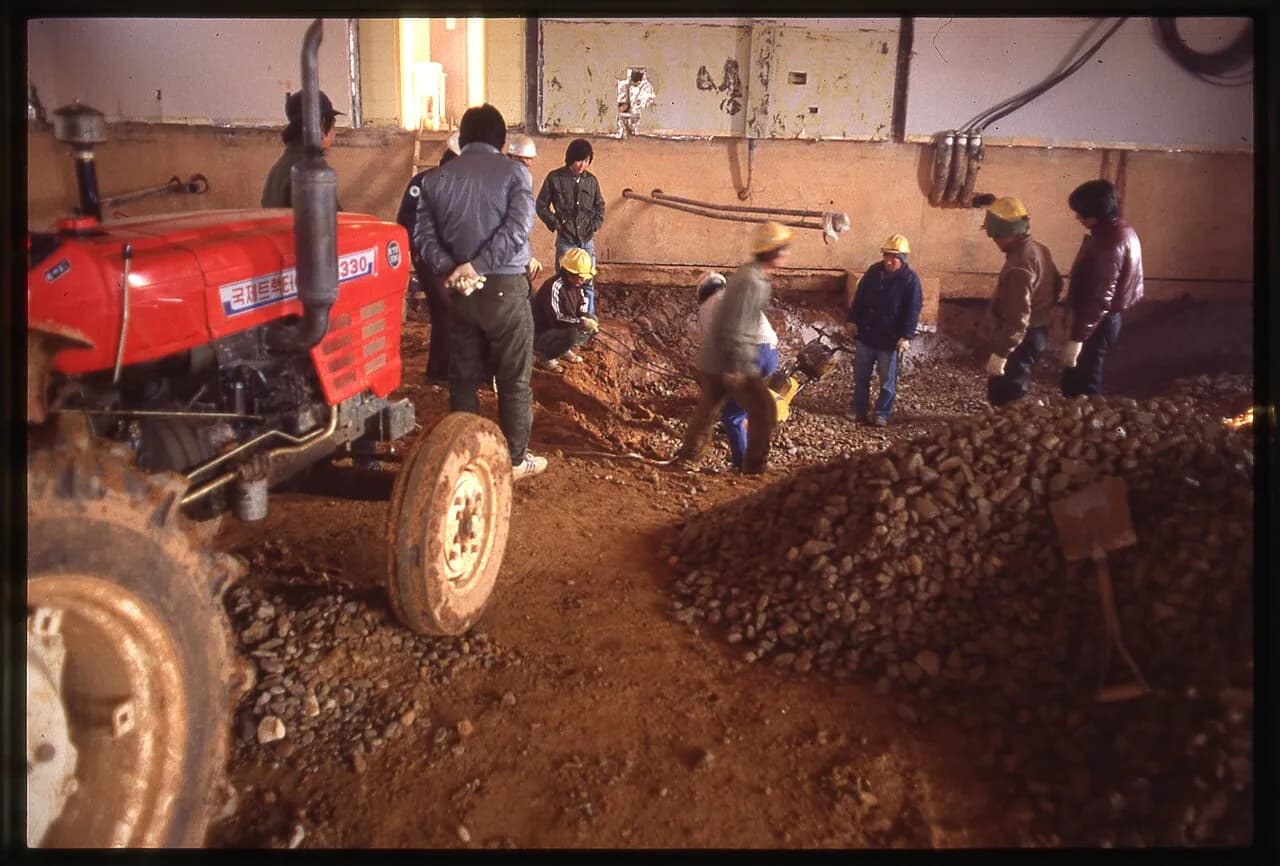 Historical U.S. Army Corps of Engineers construction photograph showing soil being mixed with cement.