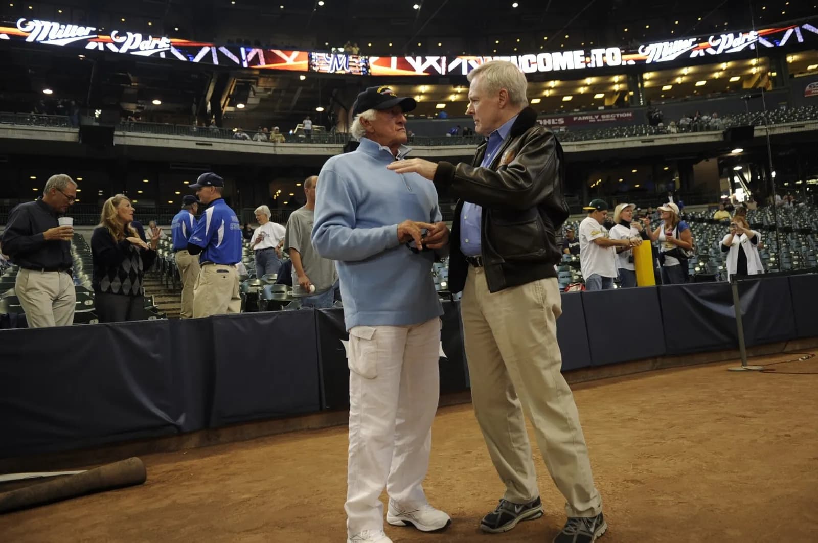 Bob Uecker receives a USS Milwaukee cap from Secretary of the Navy Ray Mabus at a Milwaukee Brewers game.