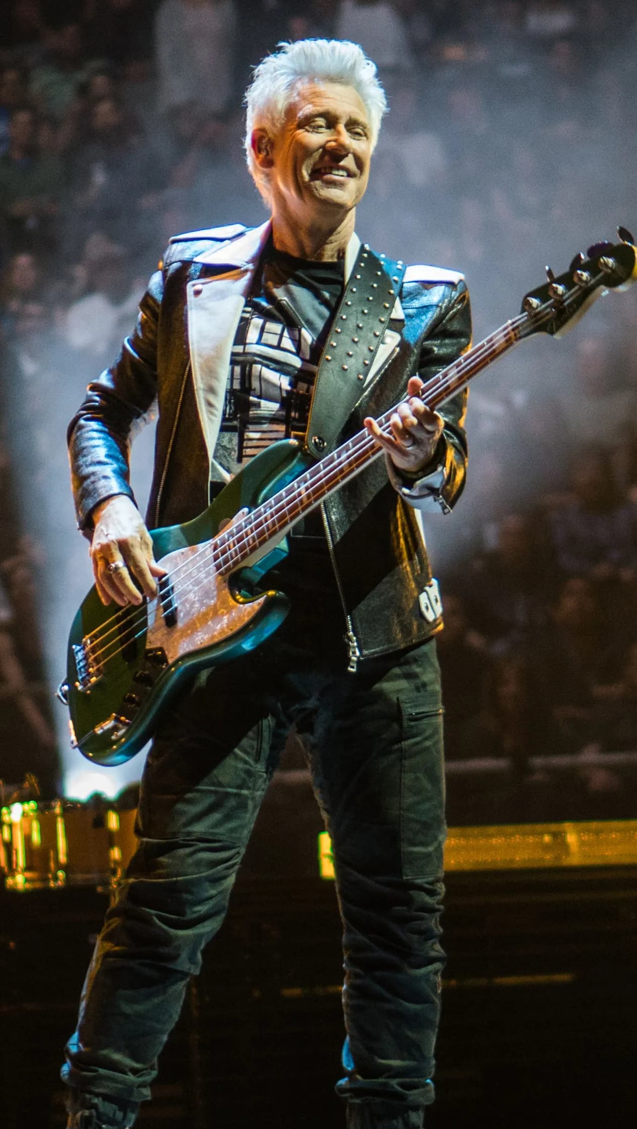 U2 bassist Adam Clayton performing onstage at SAP Center in San Jose.
