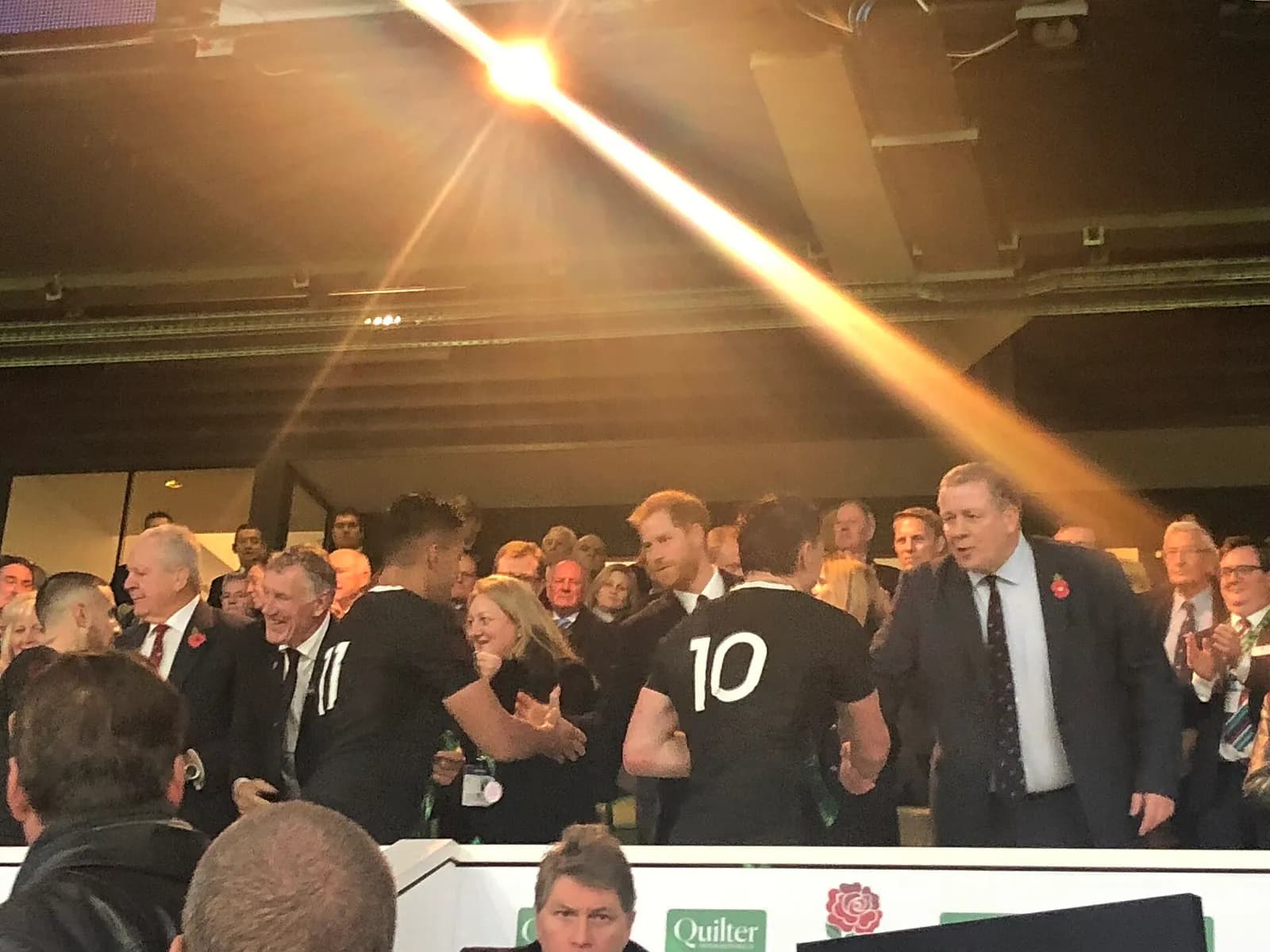 All Blacks players are congratulated by Prince Harry in a stadium hospitality area at Twickenham.