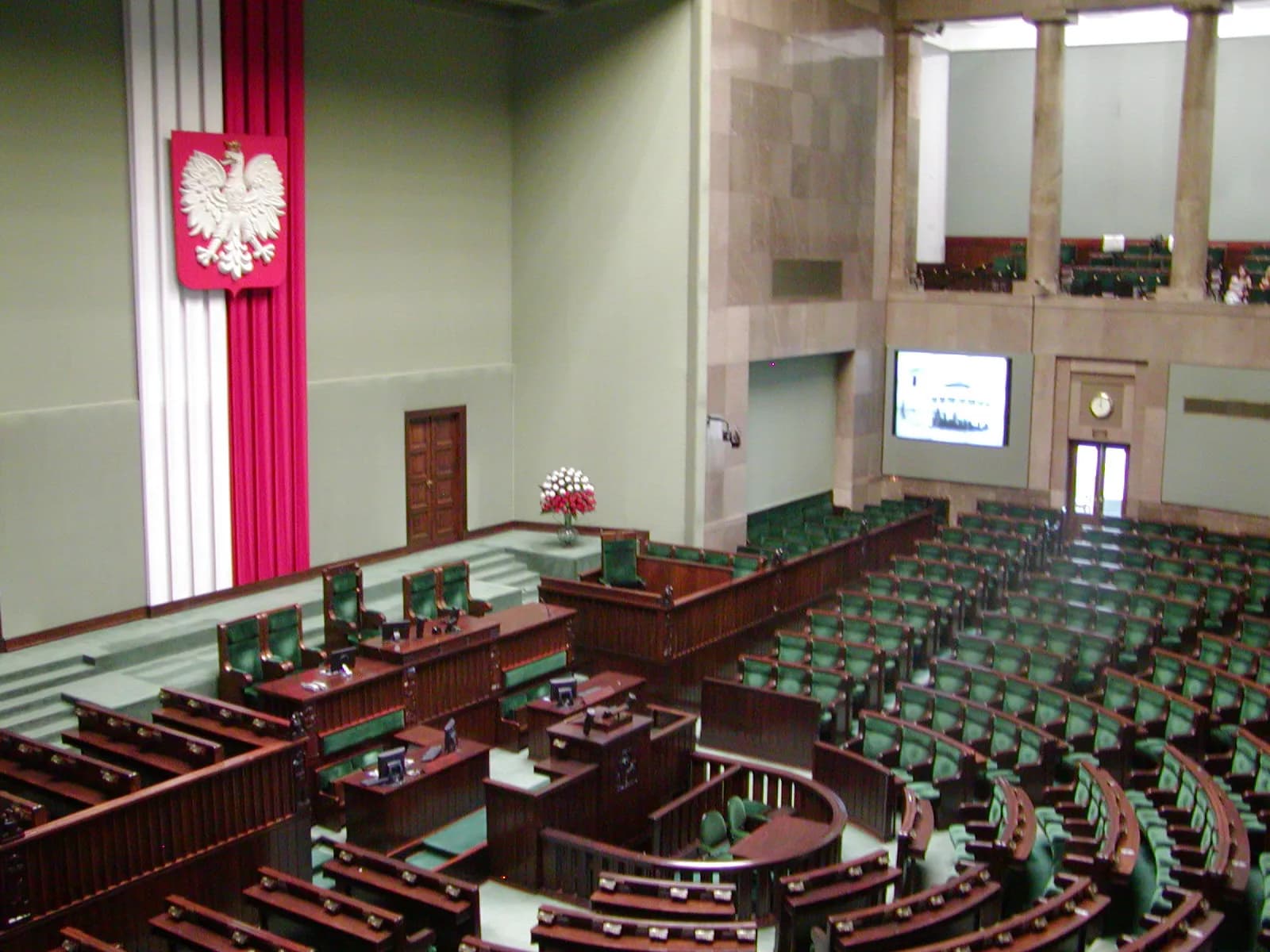 The main chamber of the Polish Sejm, with rows of seats arranged around the speaker’s chair.