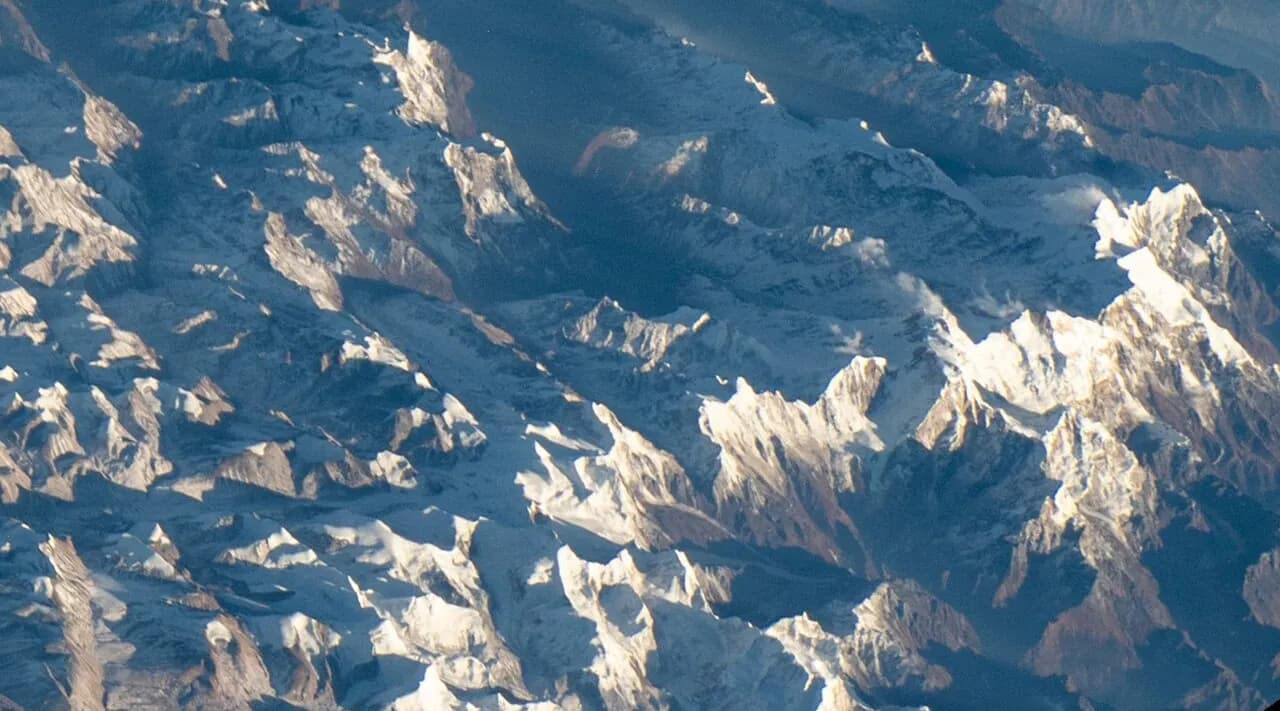 Aerial view of snow-covered Himalayan peaks, including Himlung Himal and Nimjung