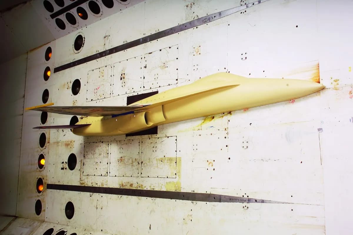 Yellow fighter aircraft model mounted inside NASA Langley’s Transonic Dynamics Tunnel