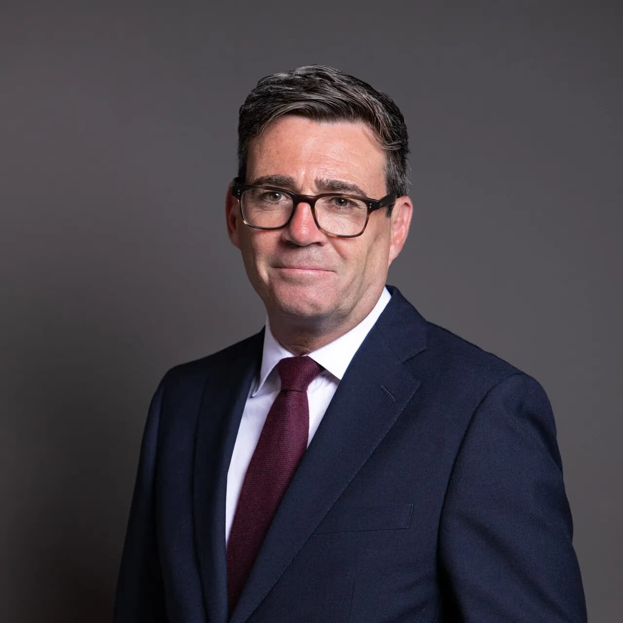 Official portrait of Andy Burnham against a plain background