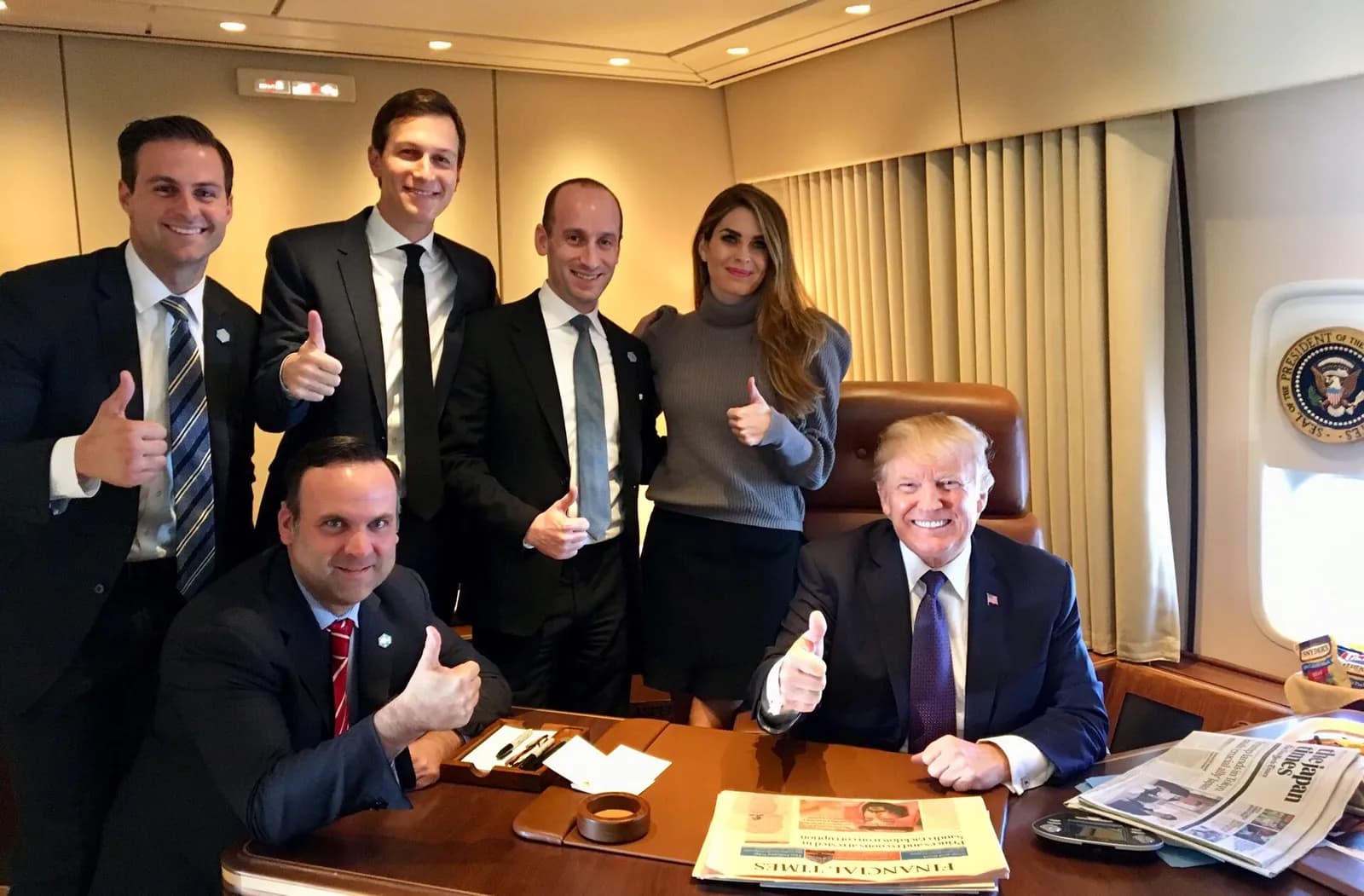 Donald Trump aboard Air Force One with White House staff