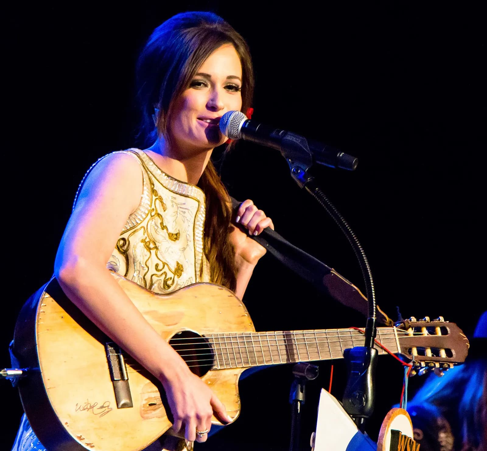Kacey Musgraves performing onstage.