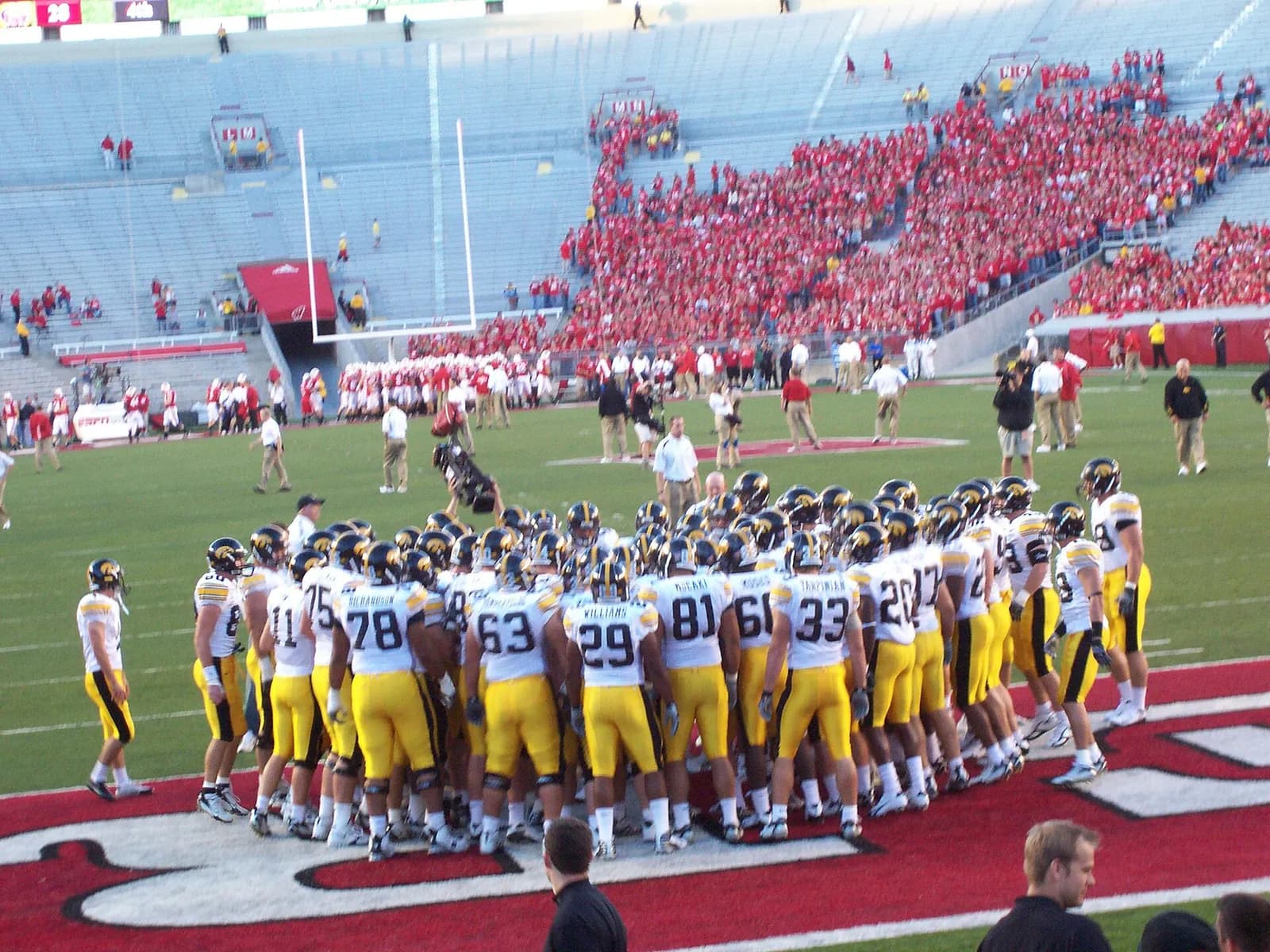 Iowa Hawkeyes players huddle before a game at Camp Randall Stadium.