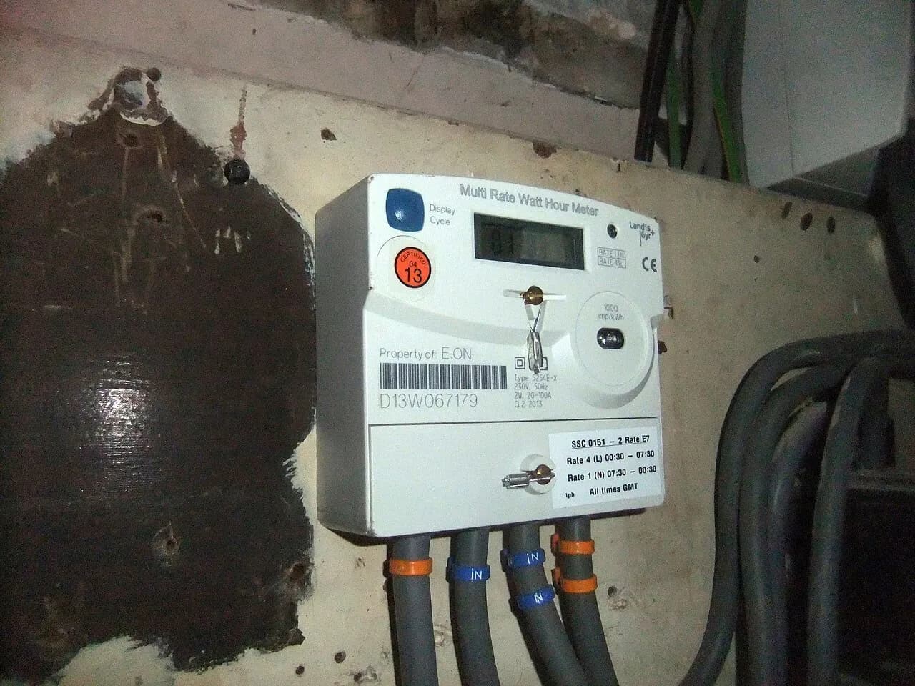 Electricity meter mounted on a board inside a house in Coventry, England.