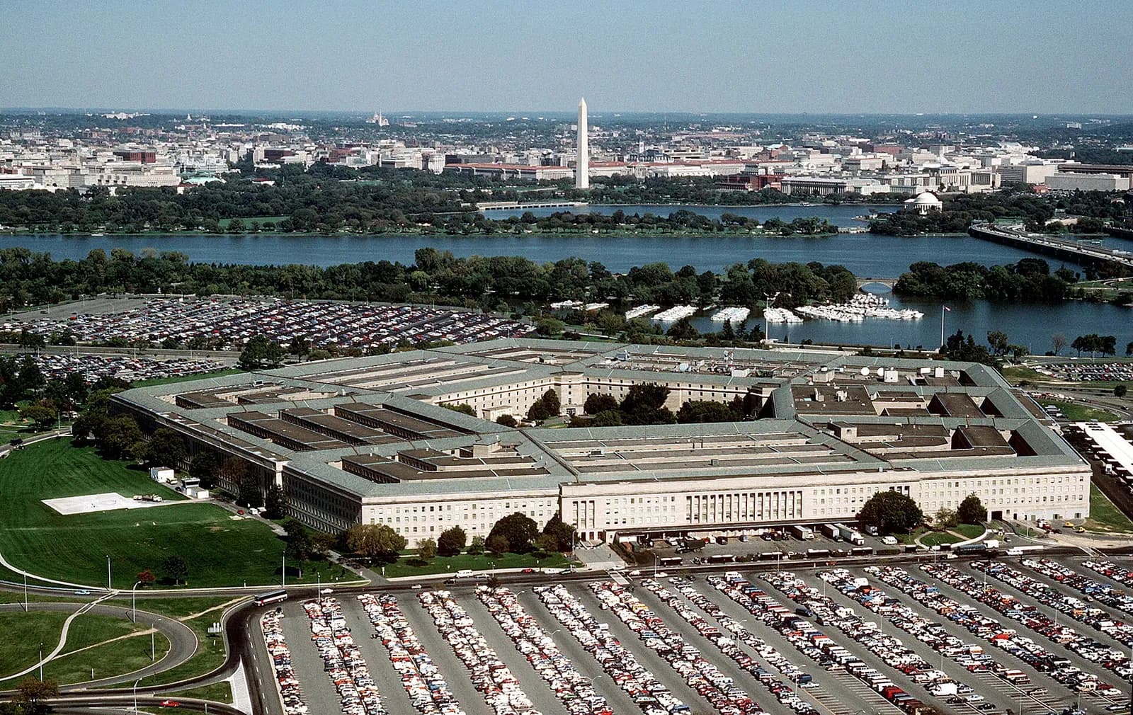 Aerial view of the Pentagon with the Potomac River and Washington Monument in the distance.