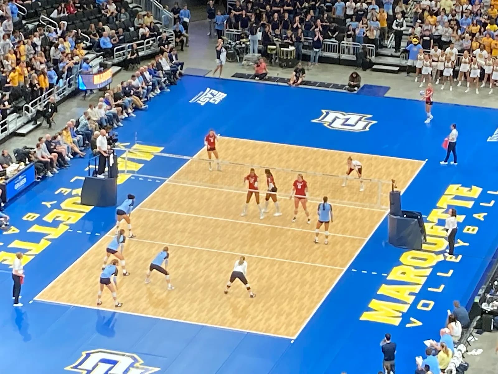Wisconsin Badgers players compete against Marquette in a women's volleyball match at Fiserv Forum.