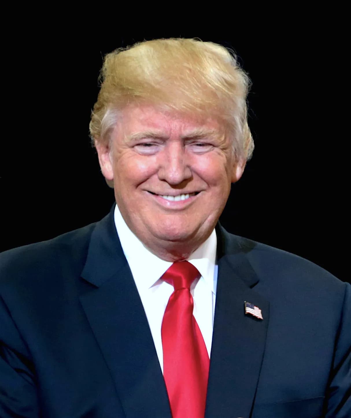 Portrait of Donald Trump in a suit and red tie.