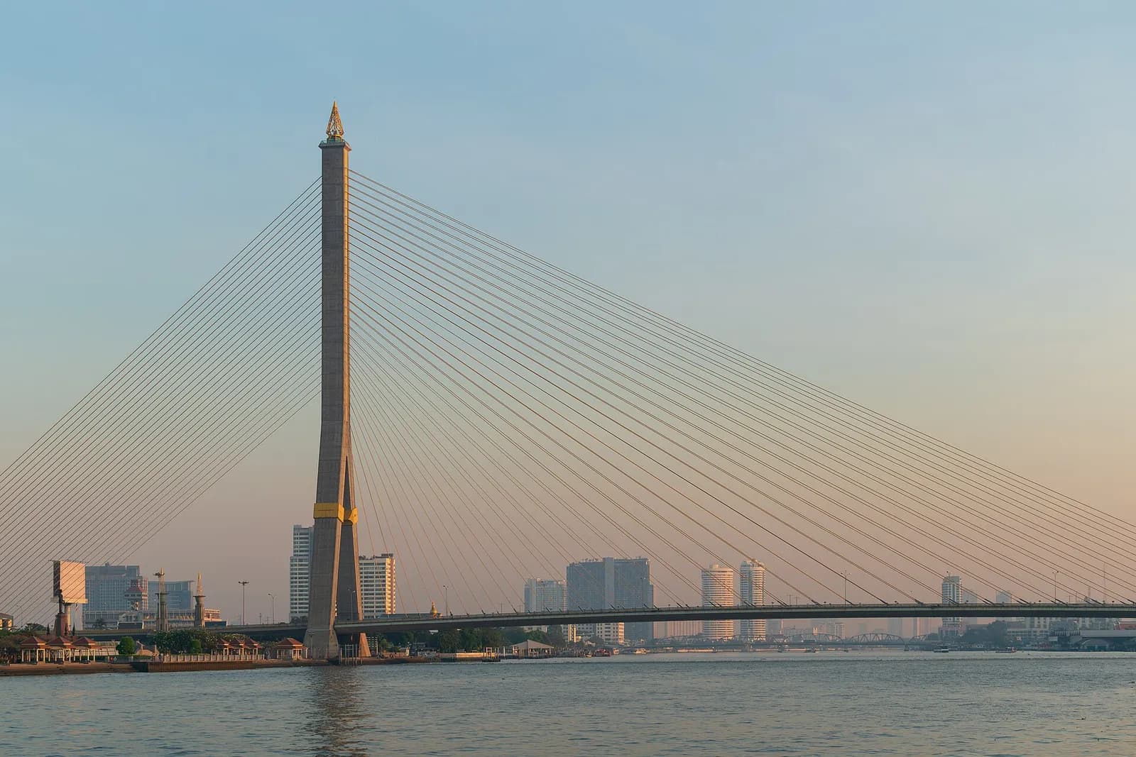 Rama VIII Bridge spanning the Chao Phraya River in Bangkok at sunrise.