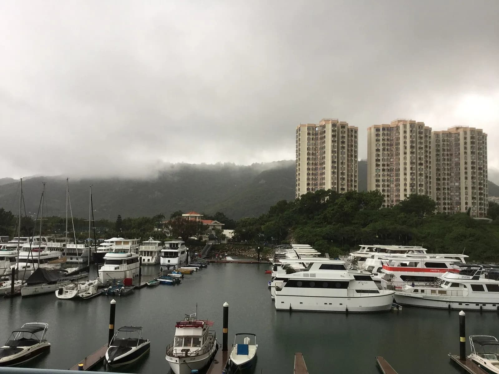Marina at Discovery Bay, Hong Kong, with yachts moored along the waterfront.