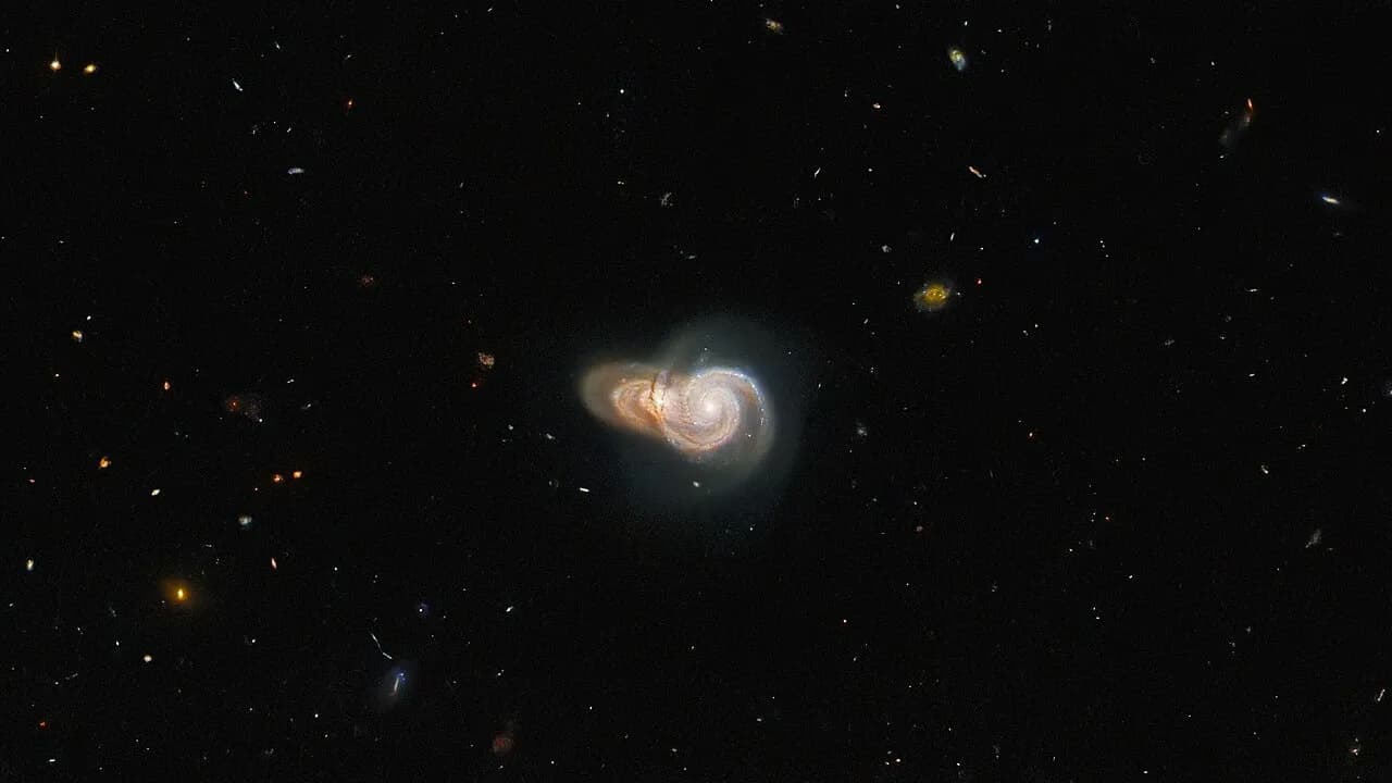 Two spiral galaxies appearing to overlap in a Hubble Space Telescope image