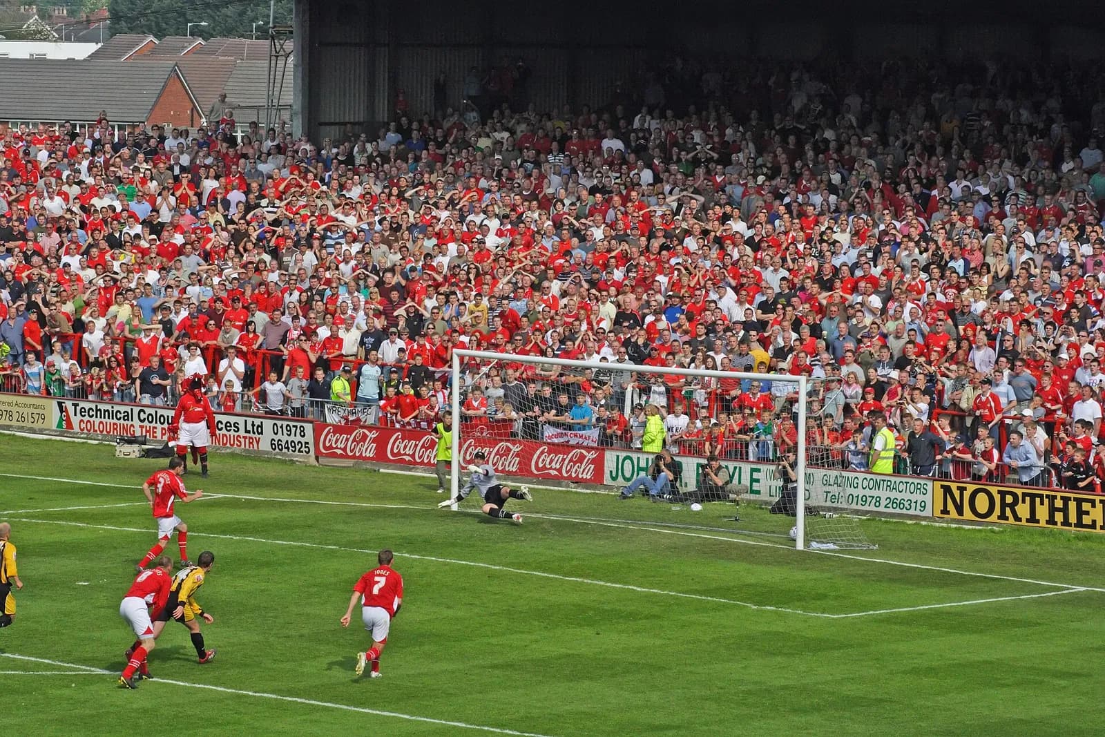 The old Kop stand at Wrexham AFC’s Racecourse Ground, with the football match in progress.