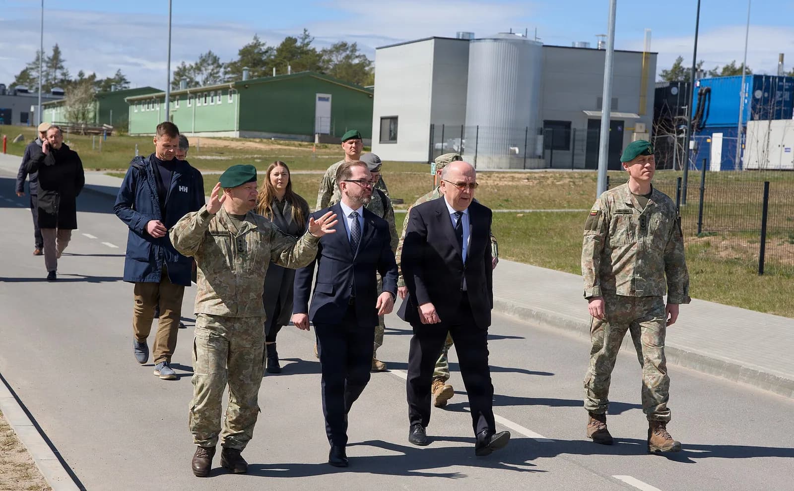 Lithuanian Defence Minister Robertas Kaunas walks with U.S. and Lithuanian military leaders at Pabradė Training Area.