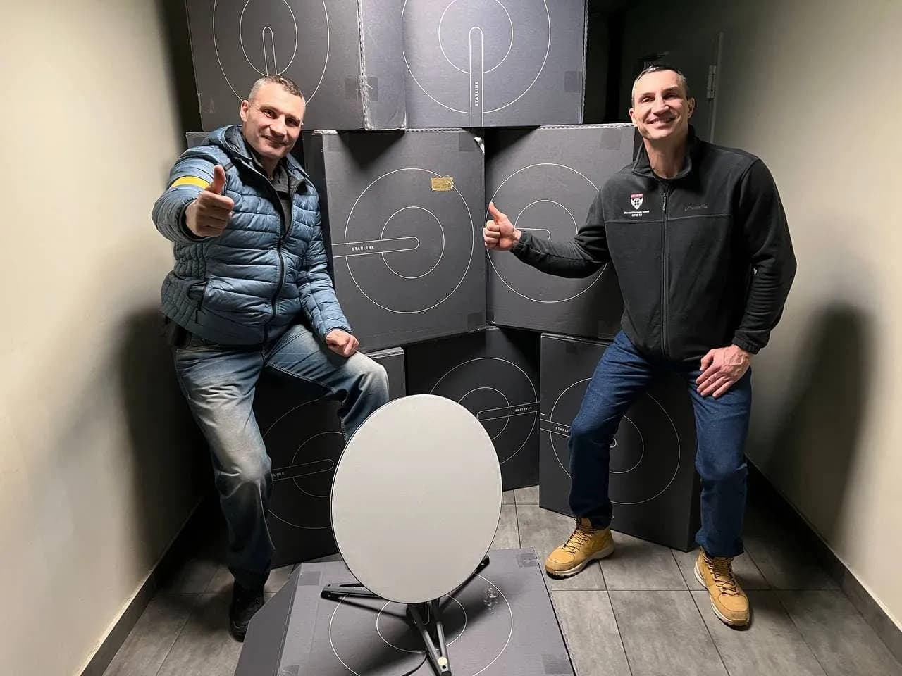 Vitali and Wladimir Klitschko pose with a Starlink user terminal in Kyiv.