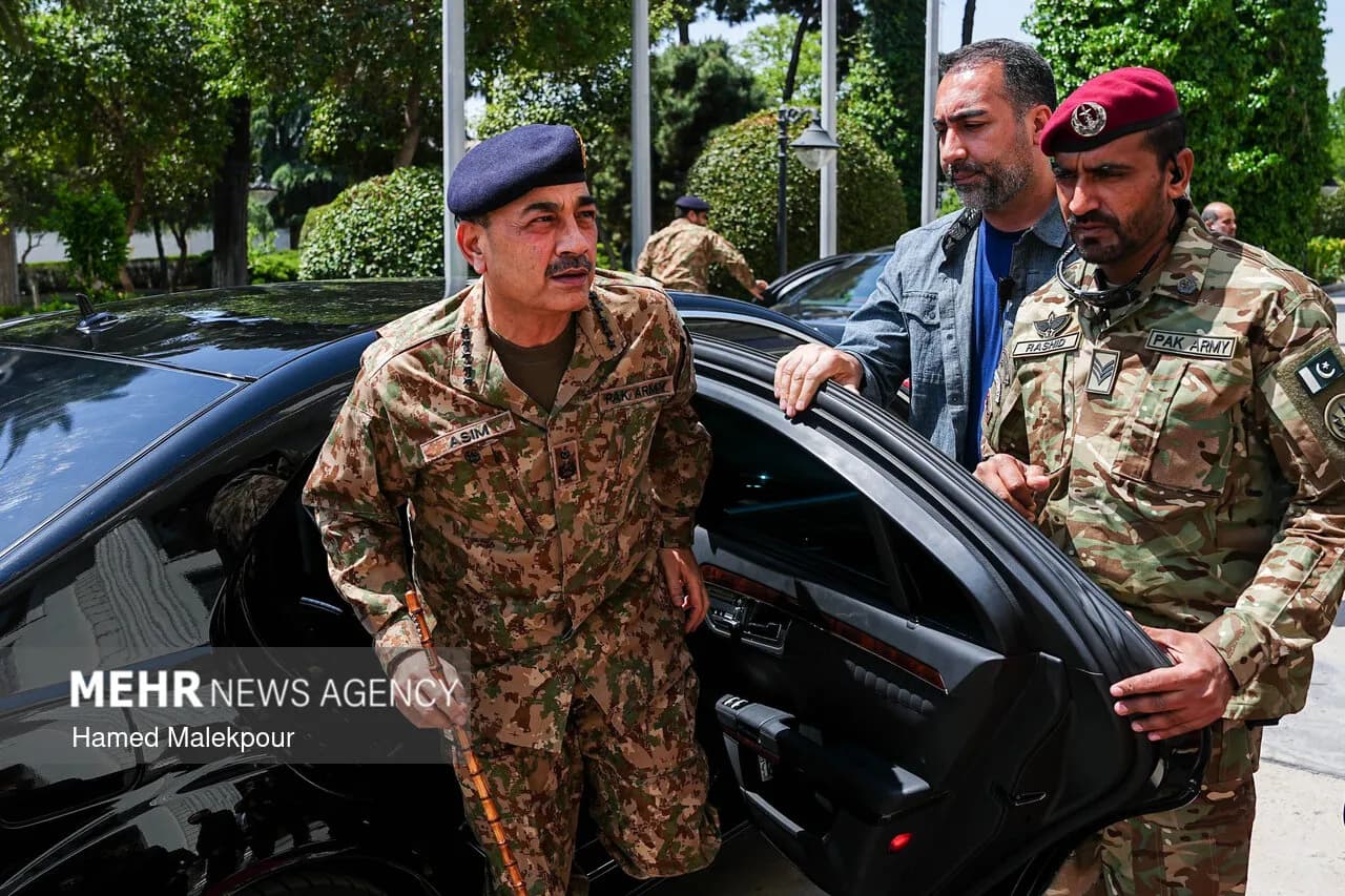 Asim Munir stands beside a car during an earlier visit to Iran.