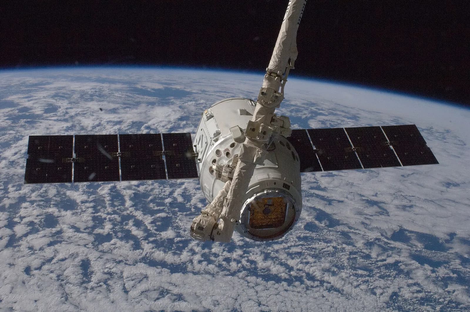 A SpaceX Dragon cargo spacecraft is held by the International Space Station’s Canadarm2 robotic arm.