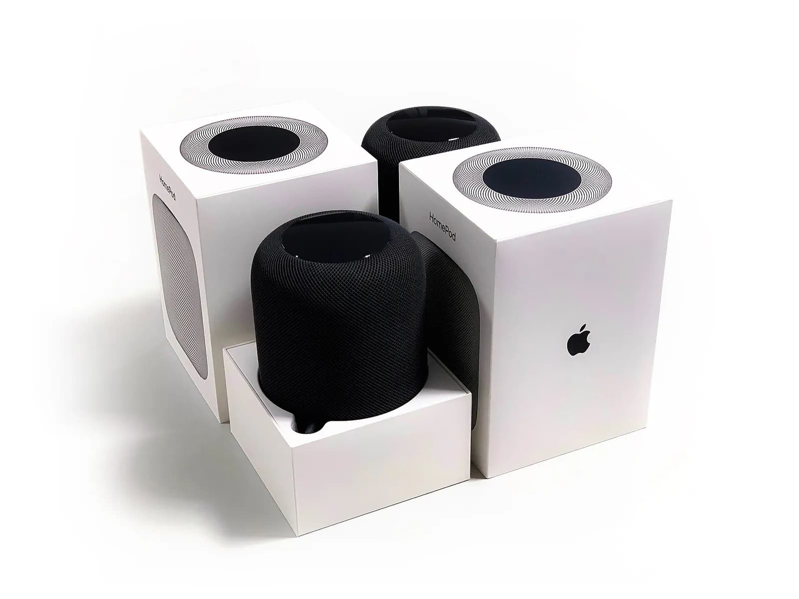 Apple HomePod smart speakers photographed together.