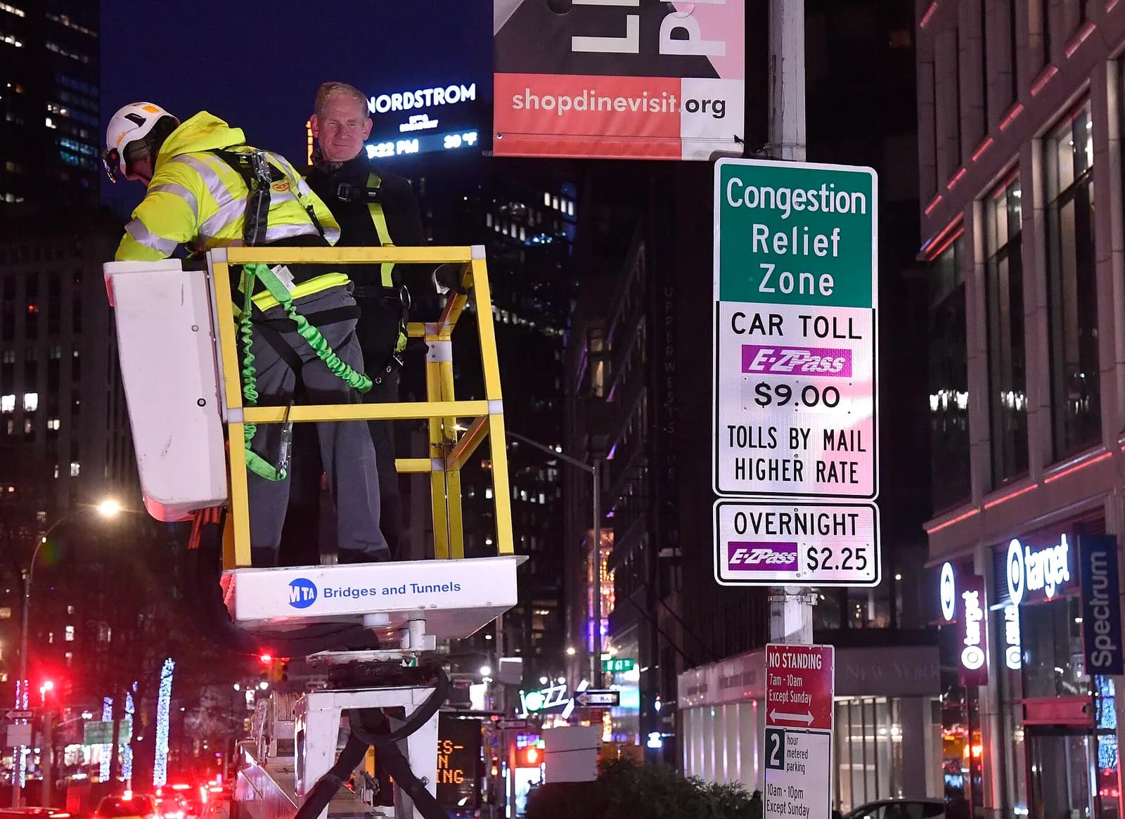 MTA Chair and CEO Janno Lieber stands beside a Central Business District Tolling Program sign on Broadway in Manhattan.