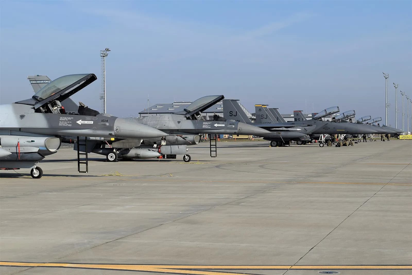 Romanian Air Force F-16 aircraft alongside U.S. F-15E aircraft at Borcea Air Base.