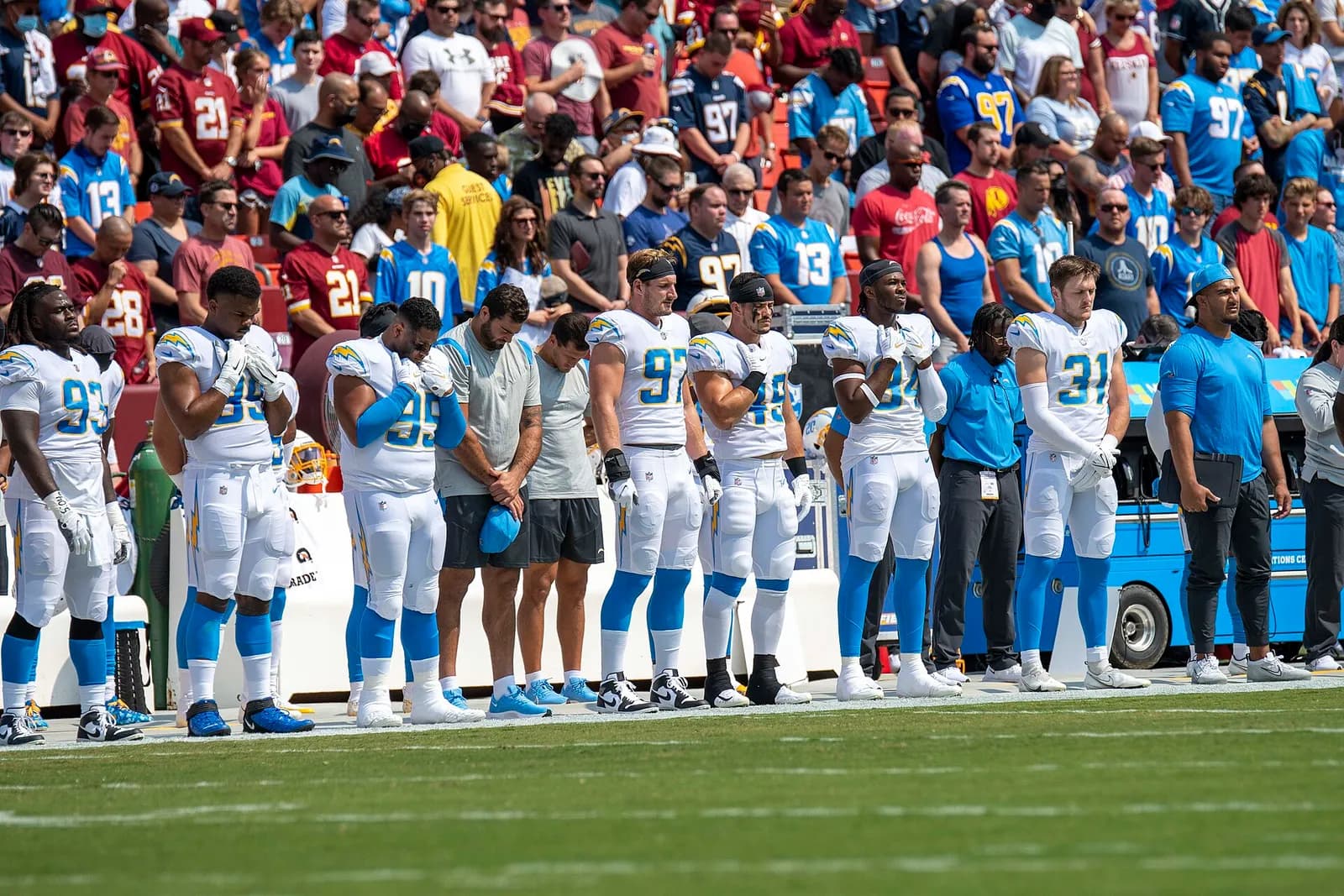 Los Angeles Chargers players and staff on the sideline at FedEx Field.