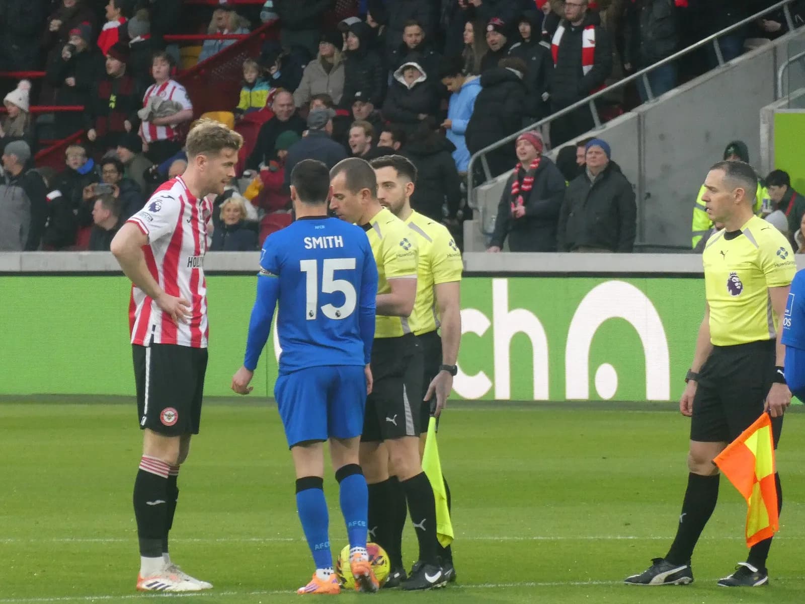Adam Smith speaks with a referee during a Brentford and AFC Bournemouth match.