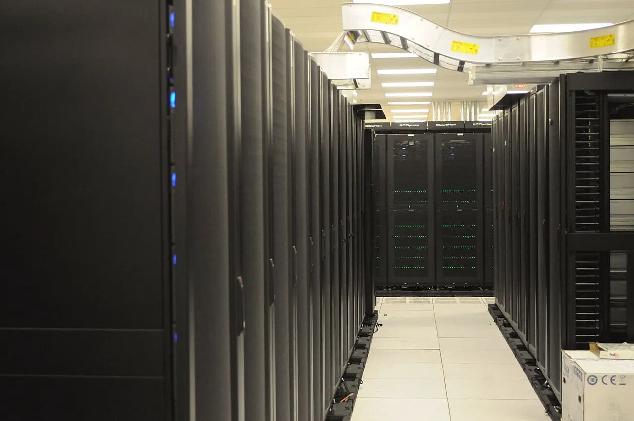 Rows of server racks with overhead cable railing at NERSC