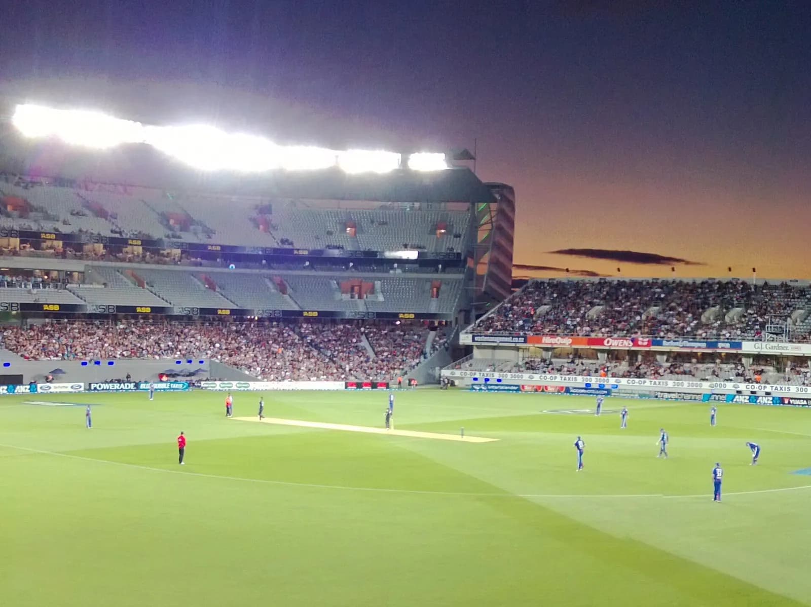Eden Park stadium in Auckland, with the south and west stands visible at dusk.