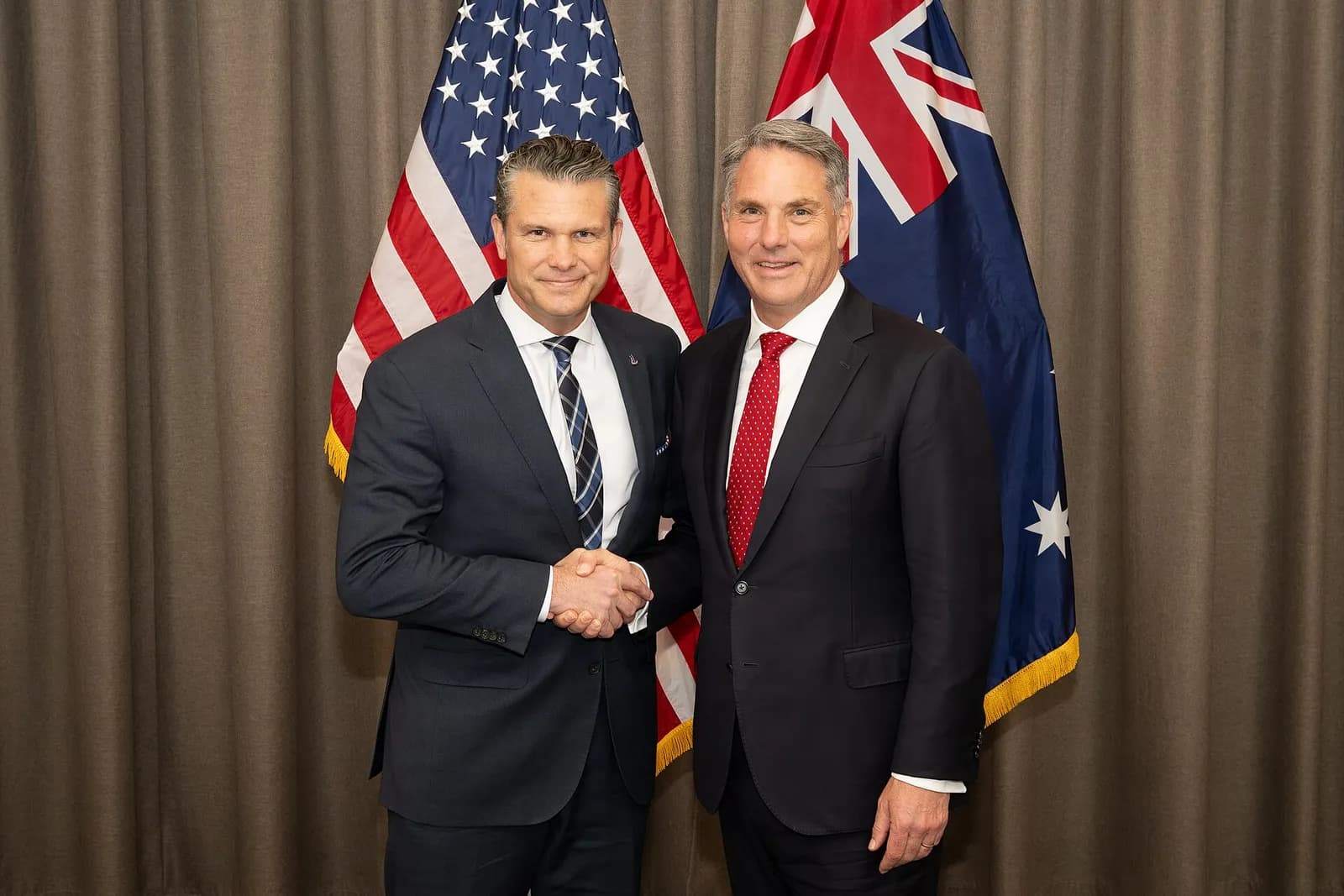 Australian Defence Minister Richard Marles and U.S. Secretary of War Pete Hegseth shake hands at a defence ministers’ meeting in Cebu.